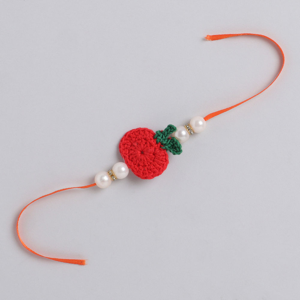 

a beautifully handcrafted red maroon floral rakhi and lumba set